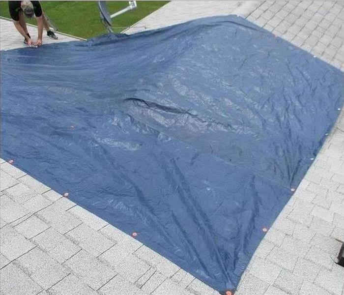 Tarp covered section of roof